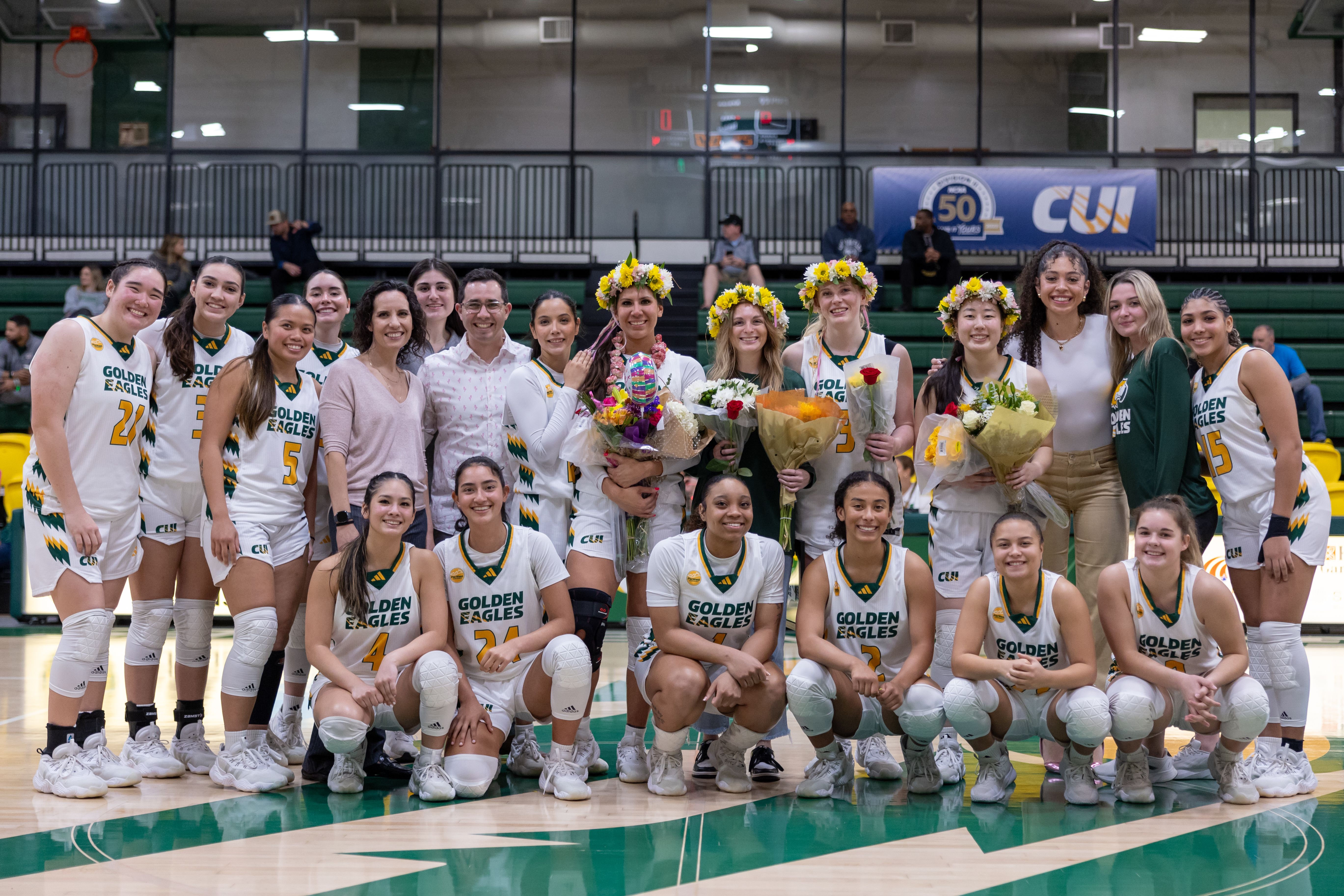 The women's basketball team gathers around the seniors